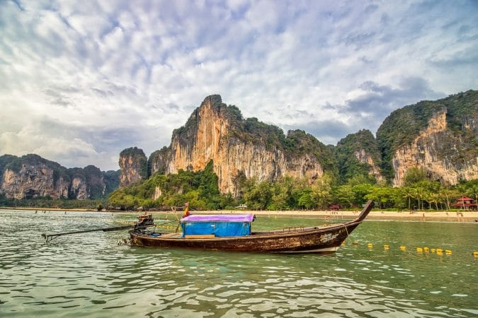 boat on water near mountains at daytime