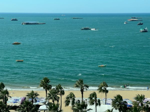 a group of boats floating on top of a large body of water