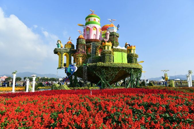 A large flower garden with a castle in the middle